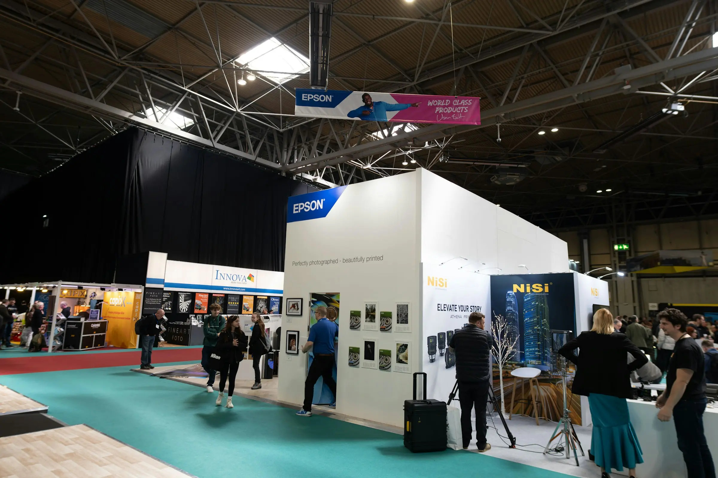 An exhibition stand dressed with printed panels and standees.