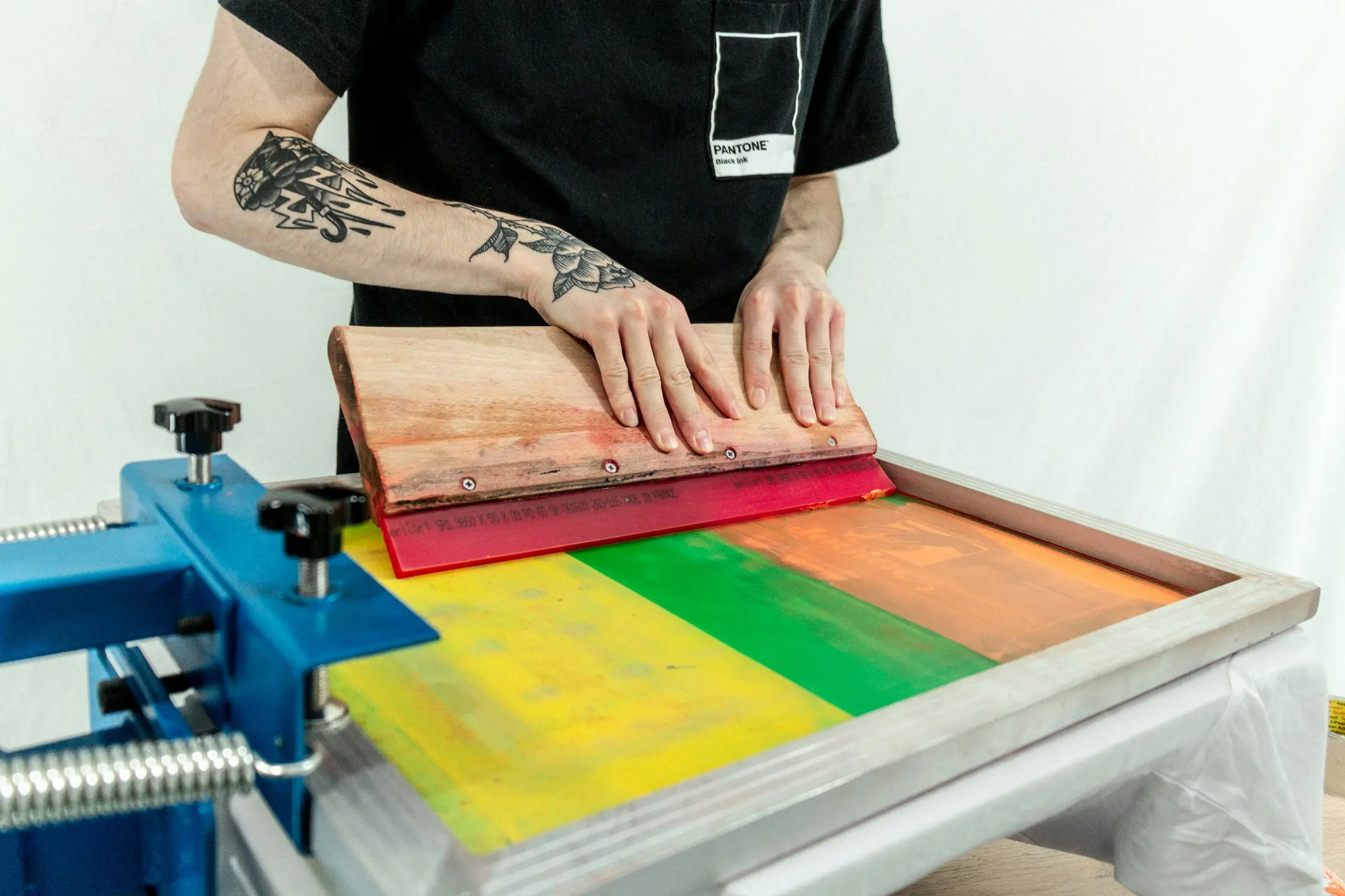 Ink rollers on a press, loaded with process colour.
