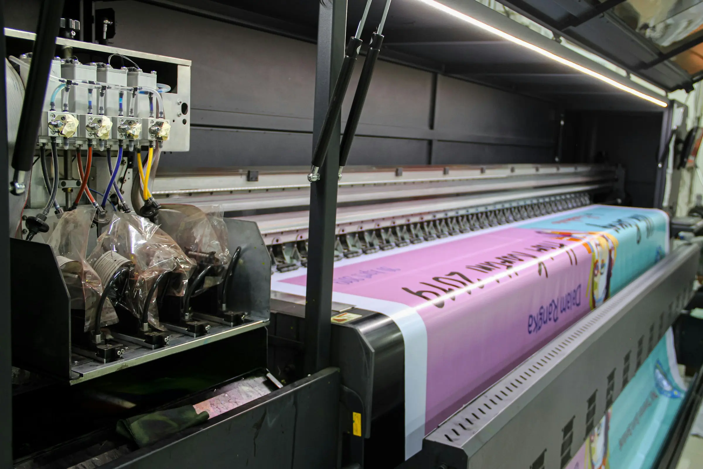 A wide-format printer laying down a banner.